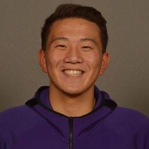 Emmett Martin smiles in front of a gray background